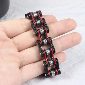 Detail of a bicolored red and black motorcycle chain bracelet with industrial link design