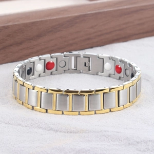 Detail of two-tone magnetic therapy bracelet with polished gold and silver steel finish