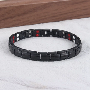 Detail view of black titanium steel magnetic therapy bracelet with multi-color inserts