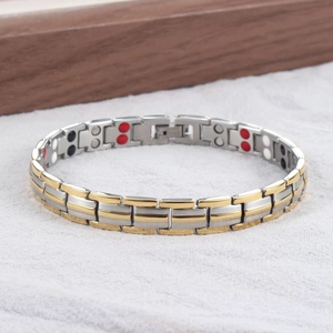Close-up of dual-row healing magnets on inner band of silver and gold titanium bracelet