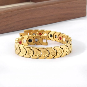 Detail of gold magnetic therapy heart bracelet showing inner functional health stones