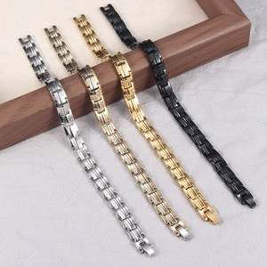 Titanium steel magnetic therapy bracelets in silver, gold, and black displayed on wood