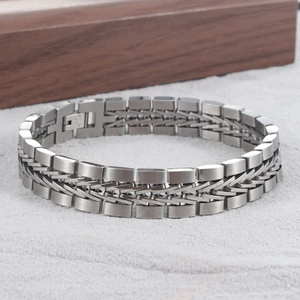 Macro detail of men's braided titanium steel bracelet with interlocking polished links