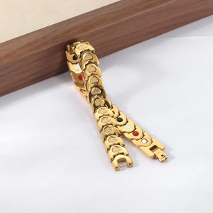 Detail of gold heart link bracelet with therapeutic magnetic inserts on wooden frame