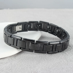 Black magnetic therapy link bracelet with glossy finish and secure folding clasp closure