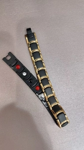 Detail view of magnetic therapy bracelet showing inner health magnets and folding clasp