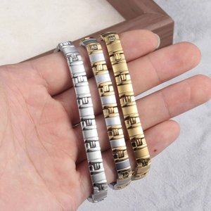 Close-up of titanium steel magnetic bracelets in silver, gold, and two-tone finishes