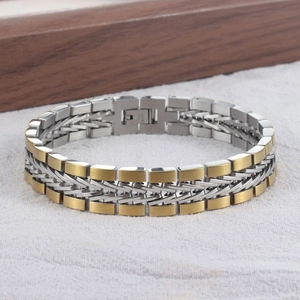 Close-up of a two-tone stainless steel braided chain bracelet with industrial texture