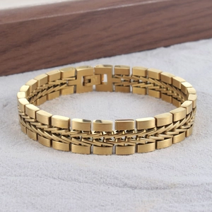 Detailed shot of golden multi-layer braided stainless steel bracelet on wooden block