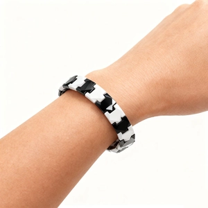 Close-up of black and white ceramic magnetic bracelet with interlocking geometric links