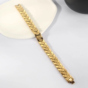 Detailed macro view of gold heart link bracelet with elegant frosted metal textures