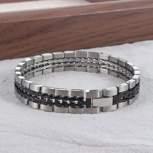Detail of vintage braided titanium steel bracelet with bicolor silver and black links