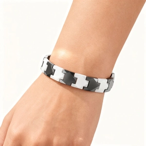 Detail of black and white ceramic magnetic bracelet worn on wrist for a modern unisex look