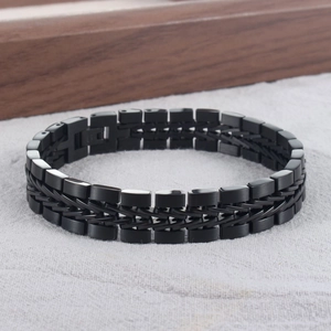 Detail of men's black stainless steel woven bracelet with polished industrial links