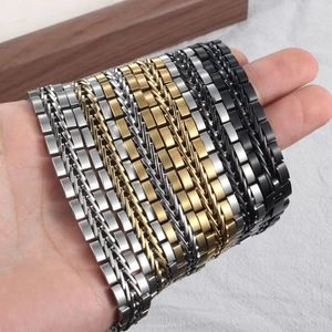 Macro detail of men's braided titanium steel bracelets in silver, gold, and black colors