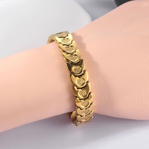 Close-up of golden chunky chain bracelet with heart textured links on model arm