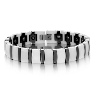 Macro shot of black and white ceramic link bracelet with magnetic therapy modules