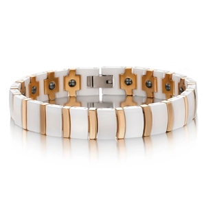 Detail of white ceramic and rose gold magnetic bracelet with black therapy stones