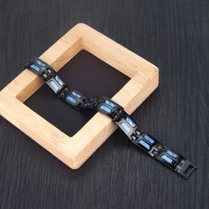 Dettaglio del bracciale magnetico nero con fibra di carbonio blu e chiusura pieghevole