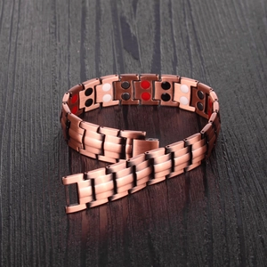 Detail of red copper magnetic bracelet showing embedded health elements and fold-over clasp
