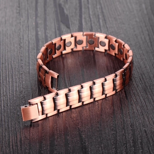 Detail of red copper magnetic bracelet showing brushed metal texture and therapy magnets
