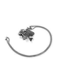 Macro detail of punk style fish bone and skull pendant in antique silver finish