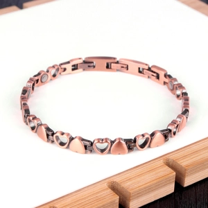 Detail of copper magnetic therapy bracelet with hollow heart links and embedded magnets
