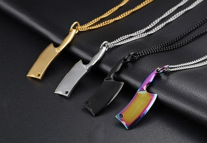Detail of cleaver-shaped stainless steel necklaces in gold, silver, black, and rainbow colors