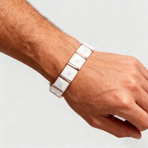 Detailed view of trendy ceramic magnetic bracelet with rose gold pyramid facets on wrist