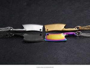 Detailed view of four punk style mini cleaver necklaces in silver, gold, black and rainbow