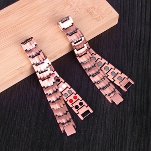 Detail of red copper magnetic bracelet showing brushed metal and functional healing elements