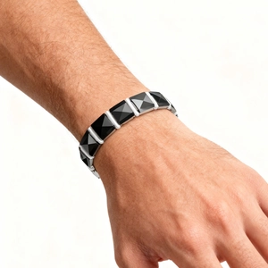 Detailed macro view of black geometric ceramic segments on a men's magnetic bracelet