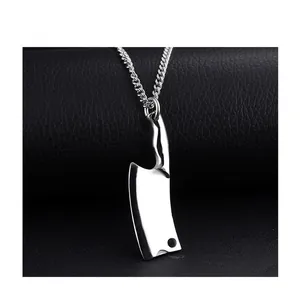 Macro shot of silver stainless steel chef knife pendant with link chain on leather