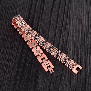 Close-up of vintage copper magnetic bracelet with cross pattern and copper engraving