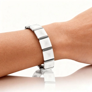 Close-up of white ceramic magnetic bracelet with geometric pyramid facets on wrist