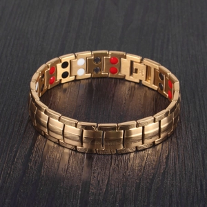 Detail of gold magnetic therapy bracelet featuring double row magnets on brushed metal