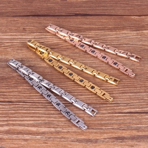 Three-color magnetic therapy metal bracelets in gold, silver and rose gold on wood