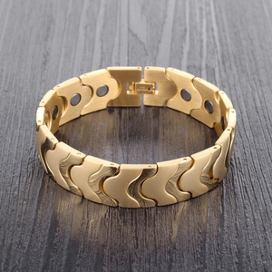 Detailed macro view of gold stainless steel magnetic health bracelet with brushed texture