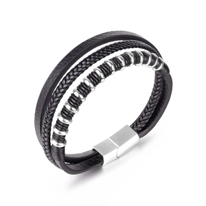 Close-up of multilayer black leather bracelet with silver beads and brushed magnetic clasp