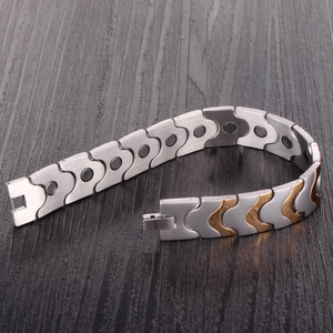 Men's wide gold and silver stainless steel magnetic bracelet with brushed metal finish