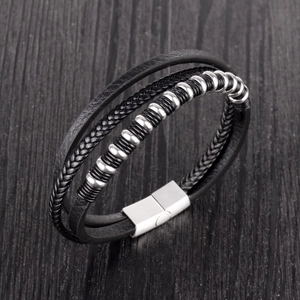 Close-up of multilayer black leather men's bracelet with silver beads and magnetic clasp