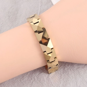 Detailed view of golden bracelet with geometric rhombus links on a model wrist