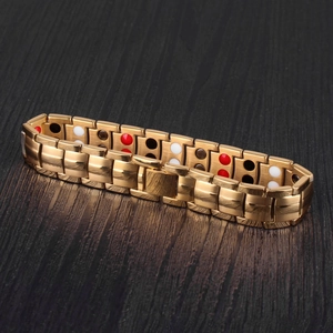 Detail of gold stainless steel magnetic health bracelet with colorful bio-elements
