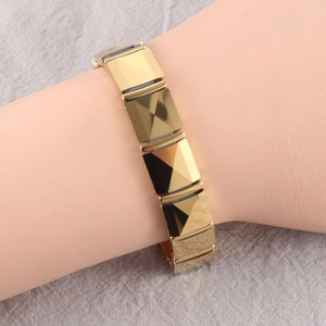 Detailed view of golden geometric square link bracelet with 3D faceted pyramid texture