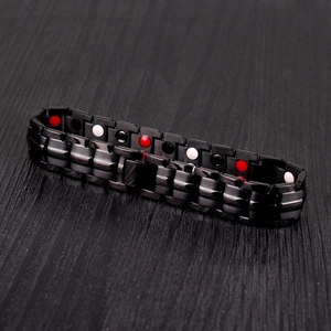Detail of black stainless steel magnetic therapy bracelet with tri-color energy stones