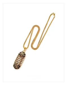 Macro view of golden abacus pendant with traditional fortune characters and pearl chain
