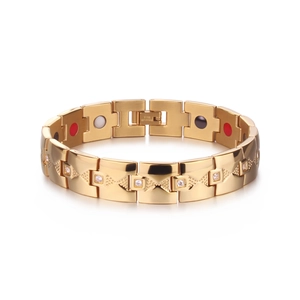 Détail macro du bracelet magnétique doré avec incrustations de zircon et texture relief