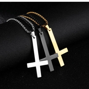 Detailed view of inverted cross necklaces in silver, black, and gold stainless steel