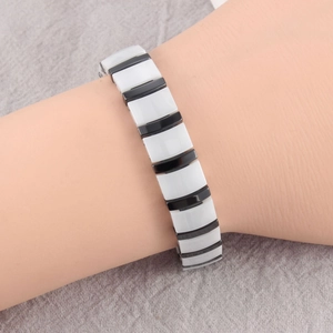 Detail shot of a monochrome ceramic link bracelet with polished black and white segments