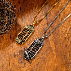 Abacus pendant necklace with Fu character in gold and silver steel on wood surface
